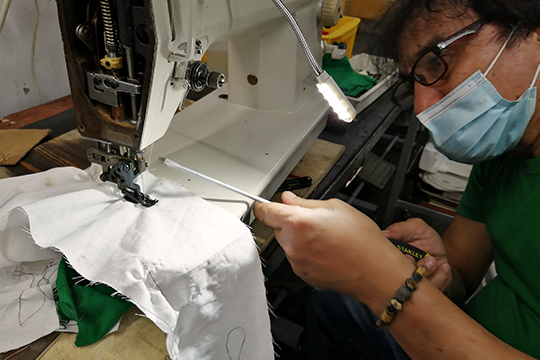 KCEI Specialist repairing an industrial sewing machine for a client